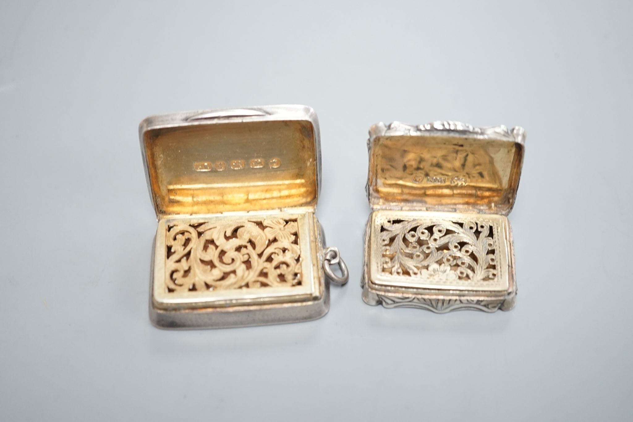 An early Victorian engraved silver shaped rectangular vinaigrette, by Nathaniel Mills, Birmingham, 1844, 31mm and a later silver vinaigrette by George Unite.